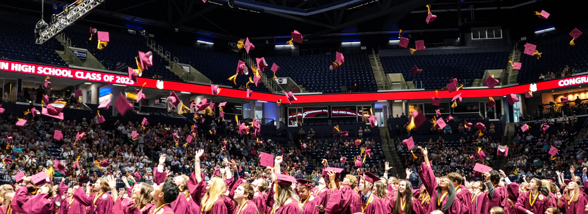 Turpin students toss their caps into the air at graduation
